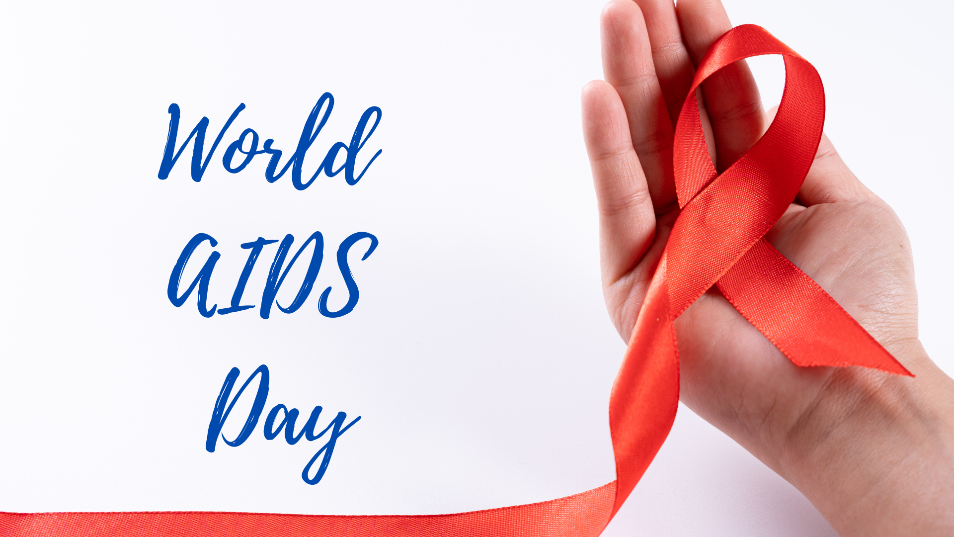 A hand holding a red ribbon with the words world aids day.