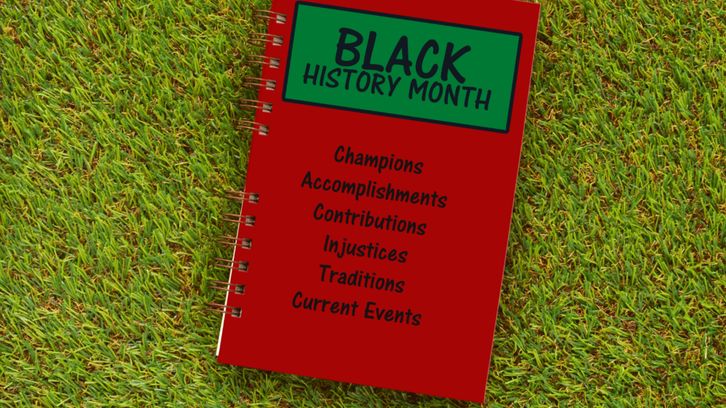 A black history month book on the grass.