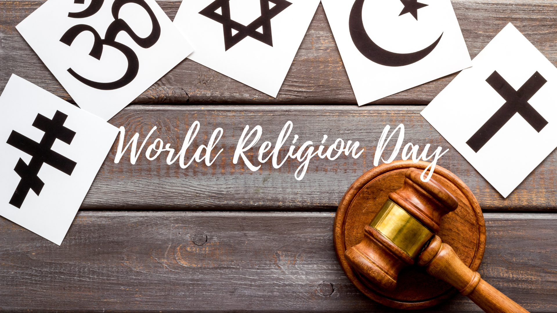 A wooden table with religious symbols and a gavel on it.