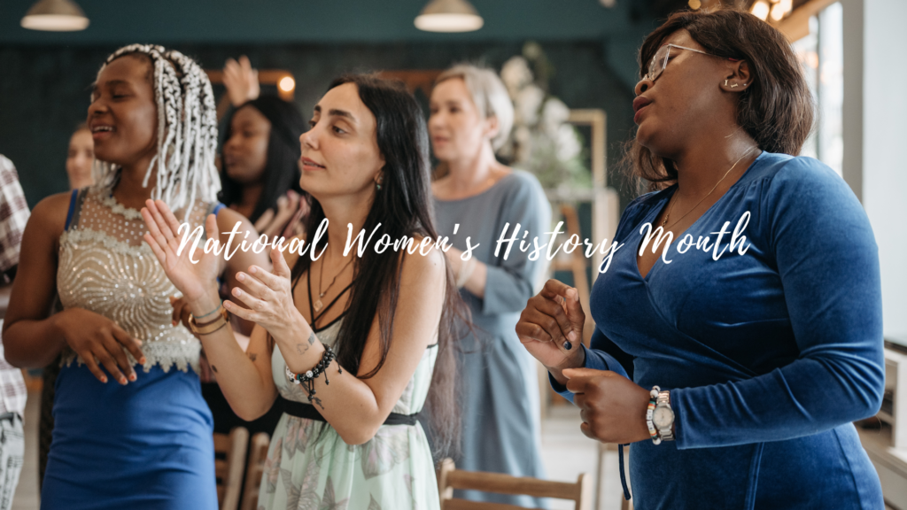 Women clapping in a room with the words national women's history month.