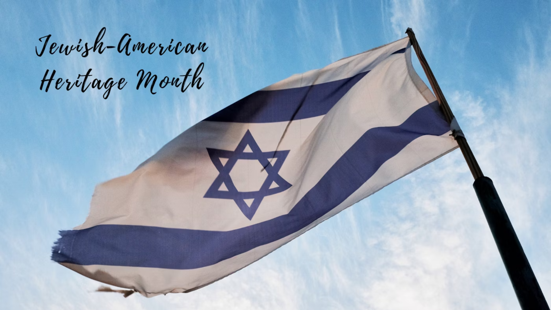 Israeli flag waving against a clear sky with the text "jewish-american heritage month" superimposed at the top.